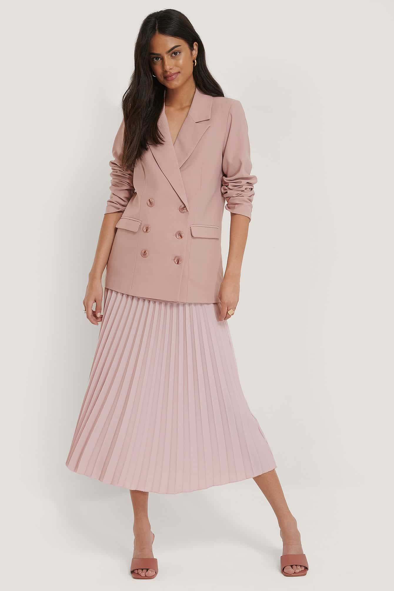 pink blazer and pink pleated skirt are pleated skirts in style