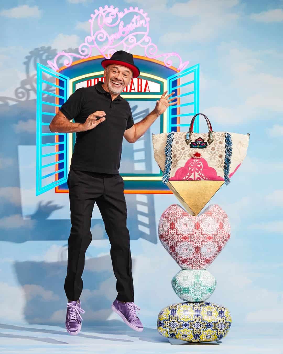 Designer Christian Louboutin smiling launch of bags