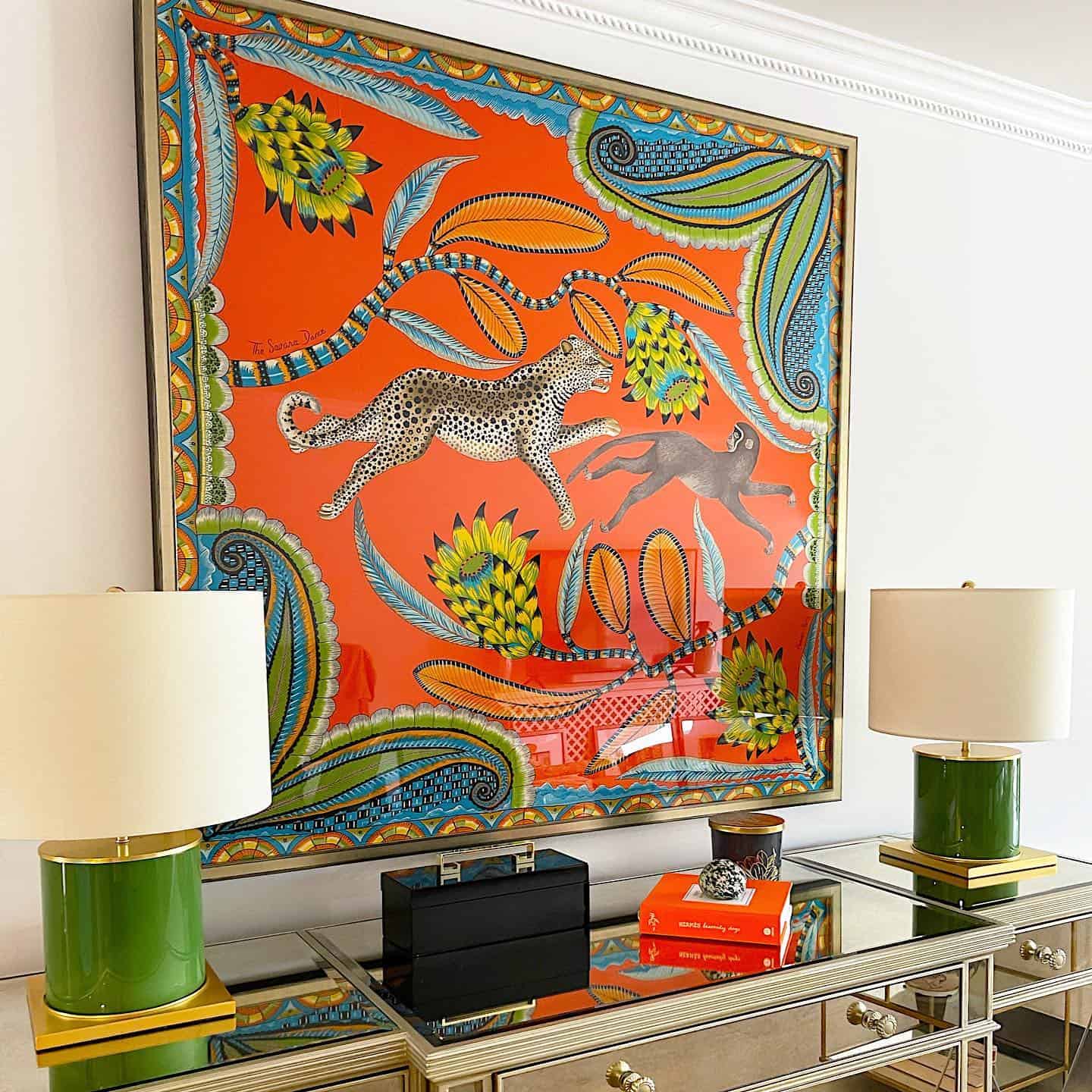 Vibrant vintage Hermes scarf framed over dresser
